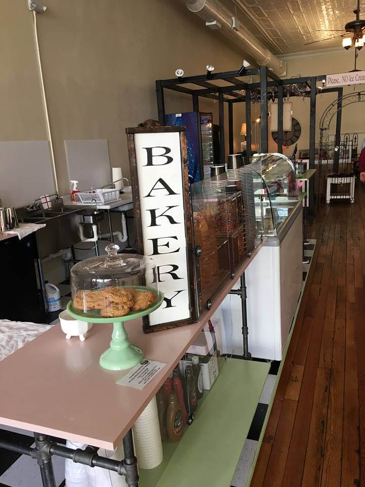A cozy bakery interior with a sign that says 