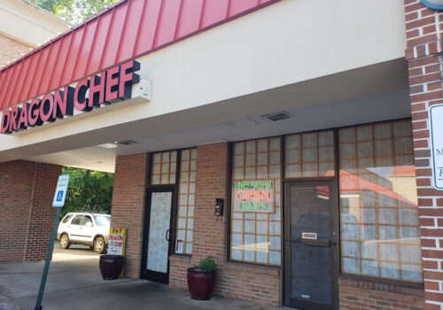 A storefront with a red and white sign reading 