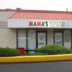 A small restaurant with a red roof and a sign that reads 