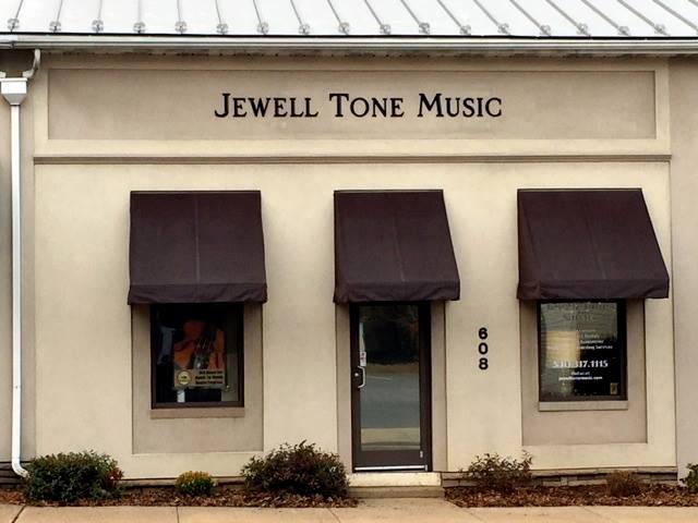 A beige-colored storefront with three windows and a central door, labeled