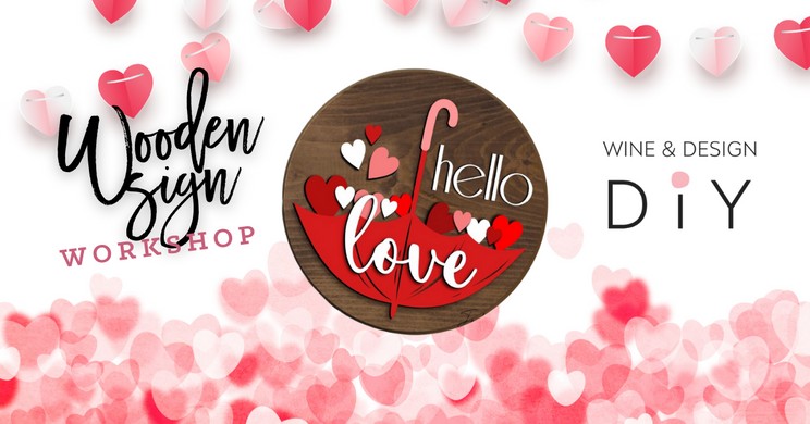 A promotional poster for a wooden sign workshop featuring the text "Wooden Sign Workshop" on the left and "Wine & Design DIY" on the right. Red and pink heart decorations surround the text, and an umbrella with "Hello Love" written inside it is in the center.
