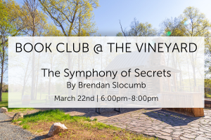 Outdoor notice promoting a book club event at a vineyard, featuring "The Symphony of Secrets" by Brendan Slocumb. The event is scheduled for March 22nd from 6:00pm to 8:00pm. Background shows a vineyard with trees and a small stone and wooden structure.