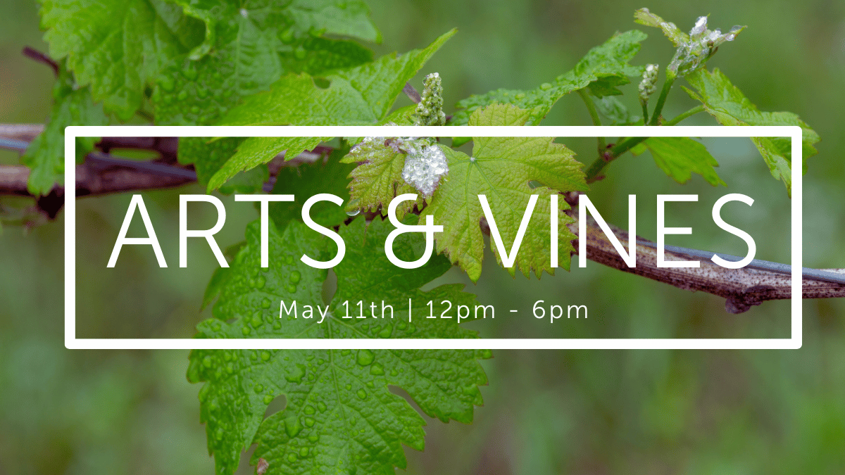 A promotional flyer titled "Arts & Vines" with the event details "May 11th | 12pm - 6pm" displayed over a background of green grapevine leaves and a branch. The font is modern and white, contrasting with the lush greenery in the background.