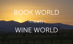 The image shows a scenic countryside with rolling hills at sunset, featuring the text "BOOK WORLD -meets- WINE WORLD" in white capital letters over the landscape.