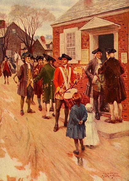 A group of colonial men, some playing drums and wind instruments, walk by a brick courthouse marker where other men and children are gathered. The scene has a historical, early American setting, with people dressed in 18th-century attire on a snowy street.