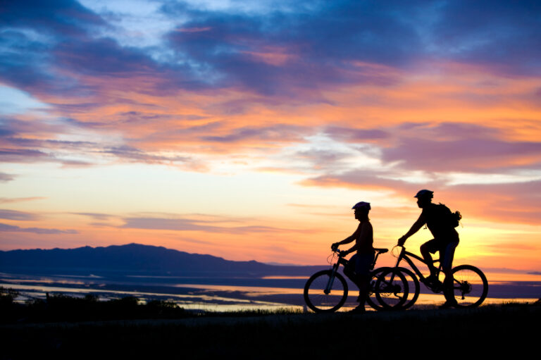couple biking with mountain view