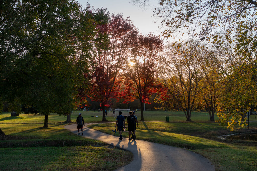 group of people walking down a paved path