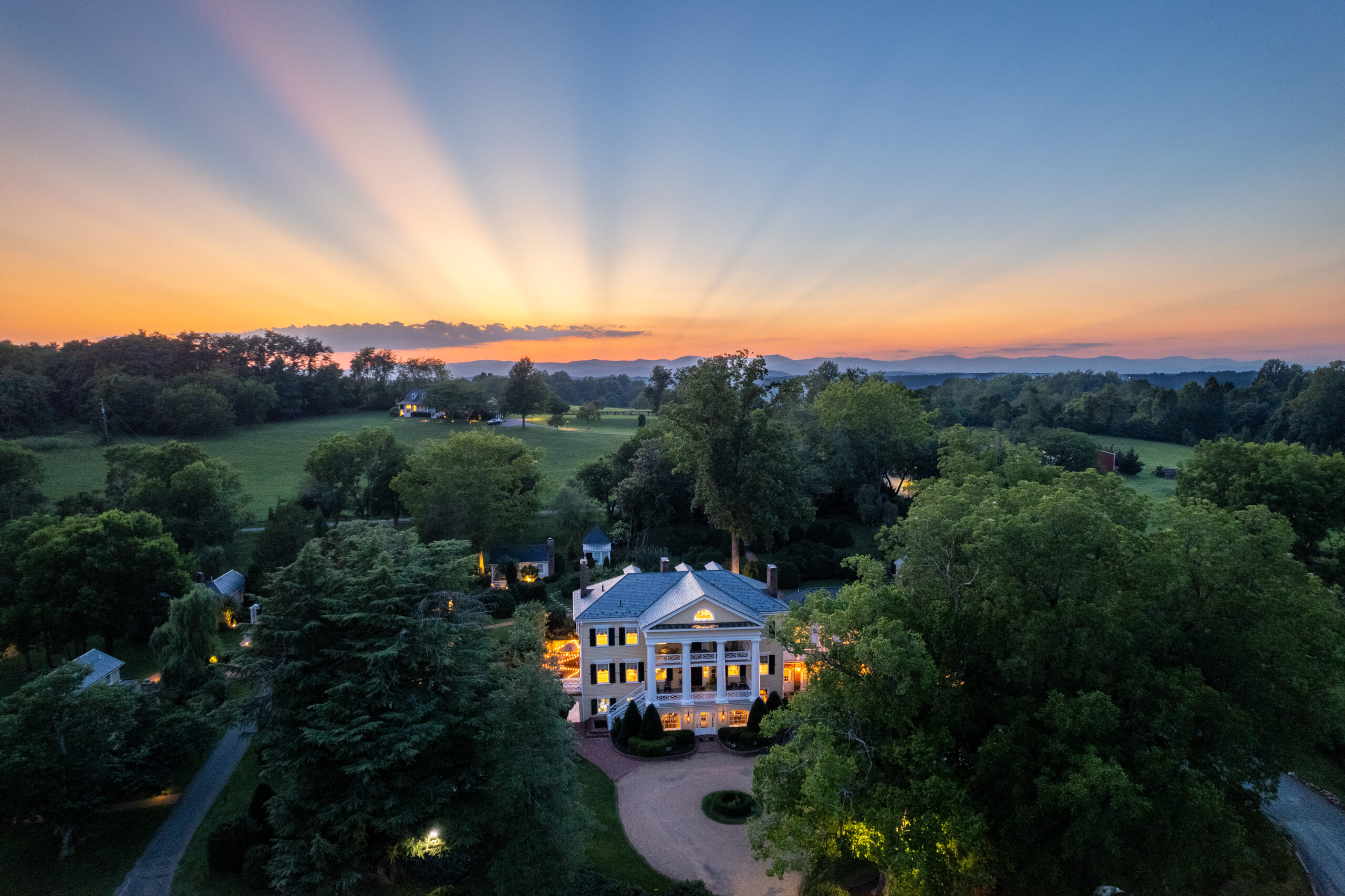 aerial image of the Inn at Willow Grove with the sun setting in the background