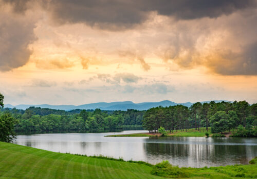 lake view with mountains in the background as the sun sets Image