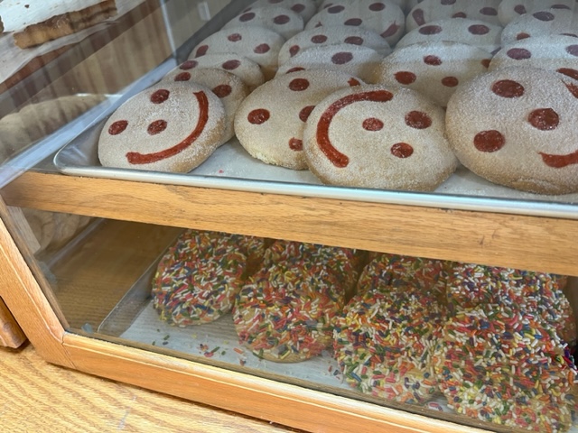 tray of smiley face cookies and cookies with sprinkles