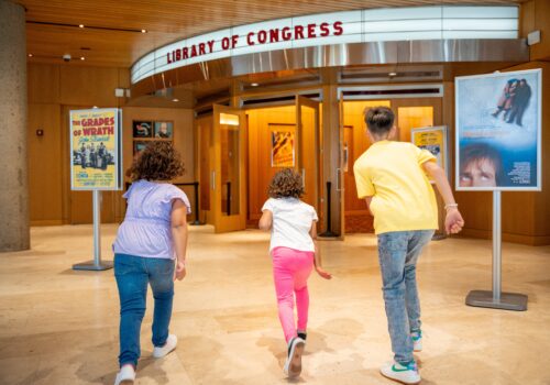 three children running into the Library of Congress Image