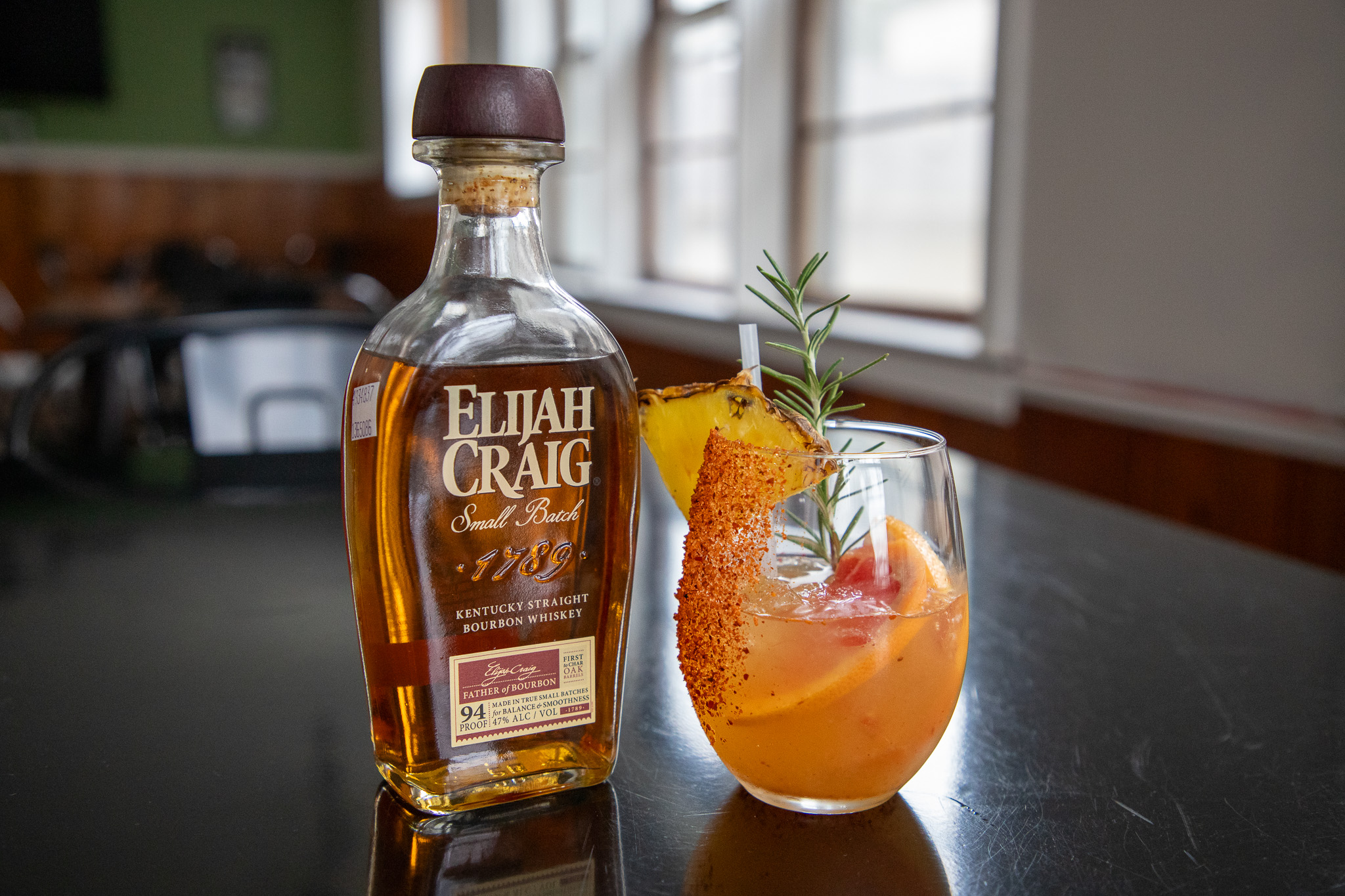 bottle of Elijah Craig with a decorative orange drink