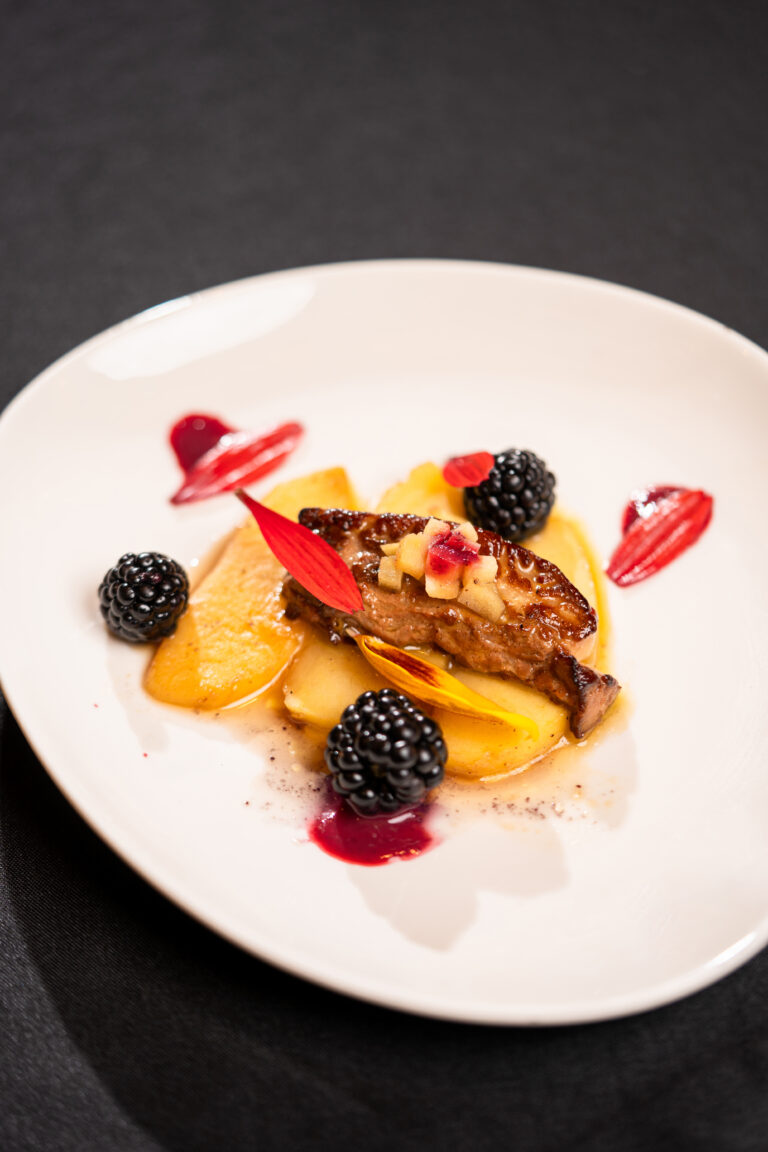 dessert on a white plate with berries